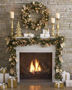 a fireplace decorated for christmas with candles and presents