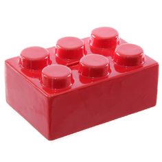 a red lego block with six round knobs