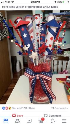 a vase filled with red, white and blue candy sticks