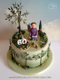 there is a cake that has been decorated to look like a man sitting on top of a tree