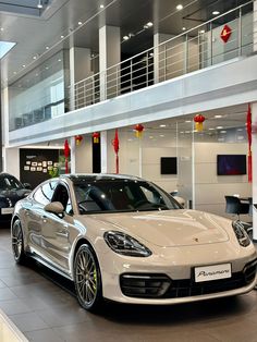 two porsche cars are parked in a showroom