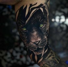 a man's arm with a tiger tattoo on it