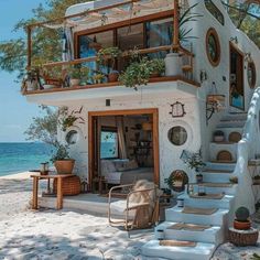 a house on the beach with stairs leading up to it