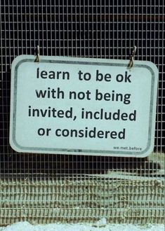 a sign that is attached to a fence with some kind of writing on it,