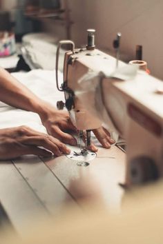 a person using a sewing machine to sew something