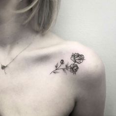 a woman with a flower tattoo on her chest