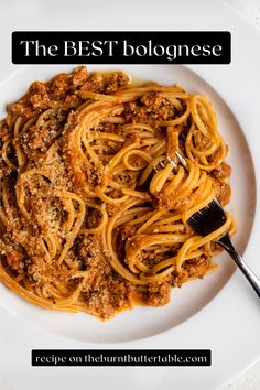 a white plate topped with spaghetti and meat