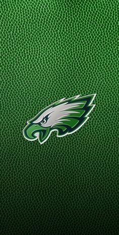 the philadelphia eagles logo is shown on a green leather surface