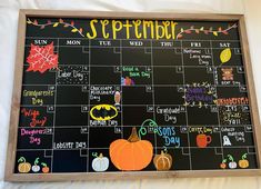 a chalkboard calendar is decorated with pumpkins and other things to do on it