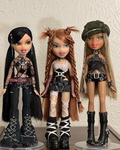 three dolls are standing next to each other