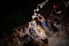 people are throwing confetti on the beach at night