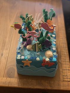 an ocean themed cake on a wooden table