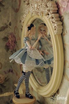 a doll is standing in front of a mirror