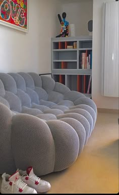 a living room filled with furniture and a book shelf