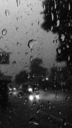 black and white photo of rain drops on window