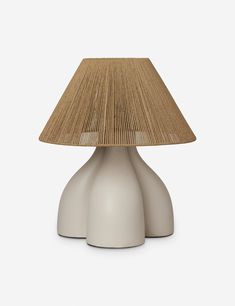 a white table lamp with a beige shade on it's top and bottom part