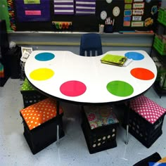 a white table with colorful polka dots on it in a room filled with children's toys