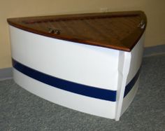 a white chest with blue stripes on the bottom and sides is sitting in a room