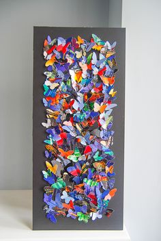 an art piece with many colorful butterflies on it