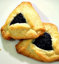 two pastries with black fillings on a white plate