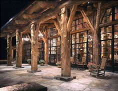 the inside of a building with wooden pillars and windows