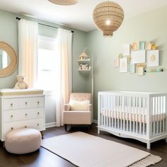 a baby's room with green walls and white furniture