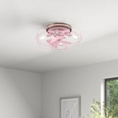 a pink ceiling light in a white room