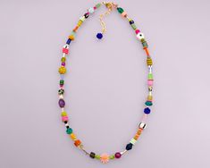 This handmade necklace features a vibrant assortment of beads, including natural gemstones, Czech glass, seed beads, African glass, pearl of pearl, shell, and crystals.  The length of the necklace is 16 inches, with a 2-inch adjustable chain. Please note that the beads may vary slightly. Etsy Beaded Necklace, Colorful Round Beaded Necklaces For Vacation, Colorful Round Beads Necklace For Vacation, Colorful Beaded Necklace For Vacation, Vacation Heishi Beaded Necklaces, Vacation Beaded Heishi Necklaces, Multicolor Heart Beads Jewelry For Vacation, Colorful Green Beaded Necklaces For Vacation, Green Beaded Necklaces For Vacation