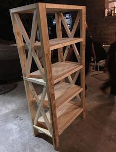 a wooden shelf sitting on top of a cement floor