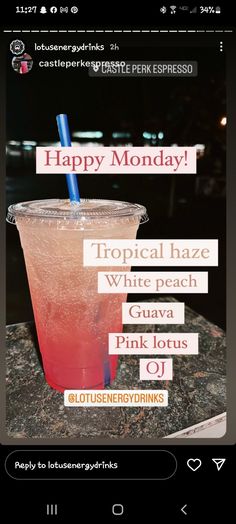 a pink drink sitting on top of a table next to a sign that says happy monday