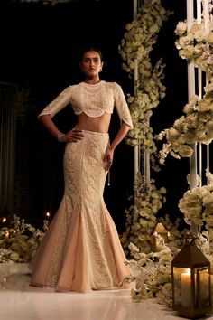 Seema Gujral: This fish cut lehenga set features intricate pearl, sequin and crystal embroidery on a powder peach net base. The ensemble is paired with a delicately scalloped blouse and an embroidered net dupatta. *This piece includes 3 - 4 inches of additional margin in the bodice/blouse to allow alterations up to 1.5 - 2 dress sizes. Fish Cut Gown, Diwali Outfit, Heavy Lehenga, Character Wardrobe, Indian Wedding Gowns