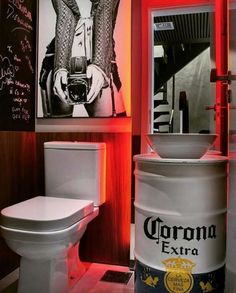 a white toilet sitting in a bathroom next to a wall with pictures and writing on it