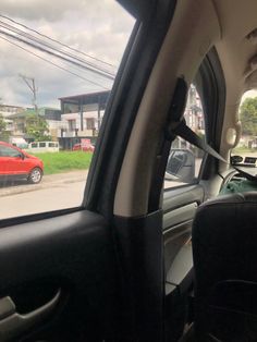 the interior of a car with cars parked on the side of the road in front of it