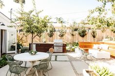 an outdoor patio with table, chairs and grill