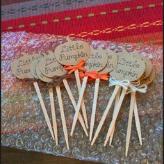 little pumpkins are on sticks with orange bows and tags that say little pumpkins