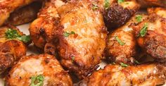 chicken wings with parsley on the side in a white plate, ready to be eaten