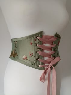 "Beautiful handmade sage / olive green floral silk corset belt with autumnal leaves embroidered, ideal for renaissance fair costume accessory. Free worldwide shipping and sent with a tracking number. Sizes available are to fit: XS: Waist: 25\" - 27\" S: Waist: 28\" - 29\" M: Waist: 29.5\" - 31.5\" L: Waist: 32\" - 33.5\" XL: Waist: 34\" - 35.5\" Crafted from gorgeous sage /olive green silk with pretty flowers and leaves embroidered all over. Dusky pink satin ribbon for front lacing. Bias binding Green Corset Belt, Floral Underbust Corset, Moss Corset, Corset Designs Ideas, Green Underbust Corset, Fairy Belt, Corset Belt Outfit, Pretty Corset, Underbust Corset Belt