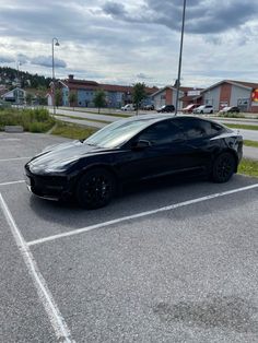 a black sports car parked in a parking lot