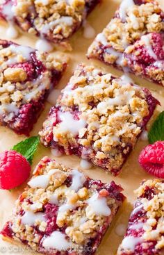 raspberry crumble bars with white icing and fresh raspberries on top