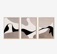 three framed art pieces with black and white designs on the wall in front of a gray background