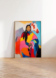 a painting on the wall in an empty room with hard wood flooring and white walls