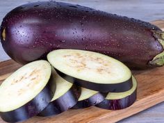 an eggplant sliced up on a cutting board