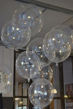 some clear balloons are hanging from the ceiling