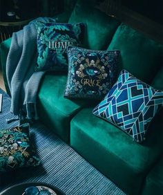 green couch with decorative pillows and throw pillows on the top, along with other items