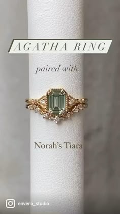 a ring with an emerald colored stone on it