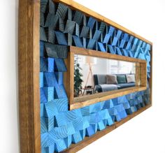 a mirror that is on the side of a wall with origami pieces in it