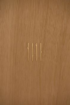 three wooden sticks sticking out of the side of a door