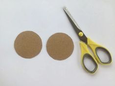 two pairs of scissors next to a pair of felt circles