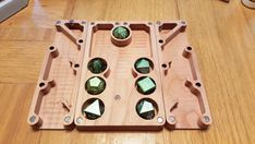 a wooden tray with four different glass pieces in it