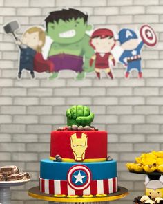 the avengers birthday cake is decorated with captain america and iron man symbols, including hulk